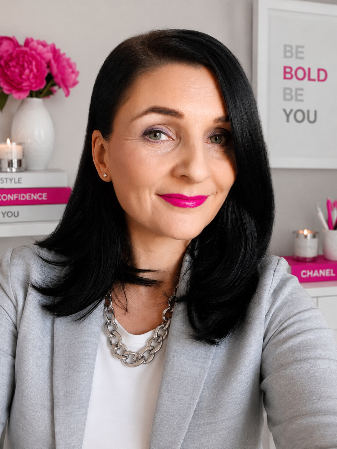 A photo of Anna Phillips with long black hair, blue grey eyes and bright red lipstick. She is an image consultant and personal stylist.