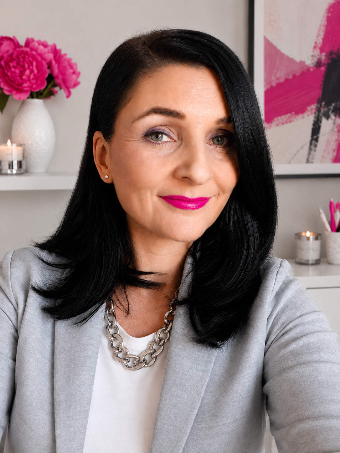 A photo of Anna Phillips with long black hair, blue grey eyes and bright red lipstick. She is an image consultant and personal stylist.